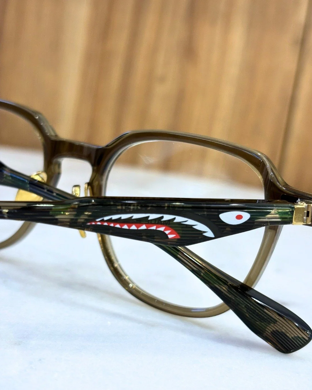 The shark was always on the side. 

A Bathing Ape slim round frame &mdash; the version of BAPE that grew up without growing out of it.

Shark teeth. Eye icon. Camo. ✨
All on the temple.
None on the front.

This is what BAPE looks like when you don't 