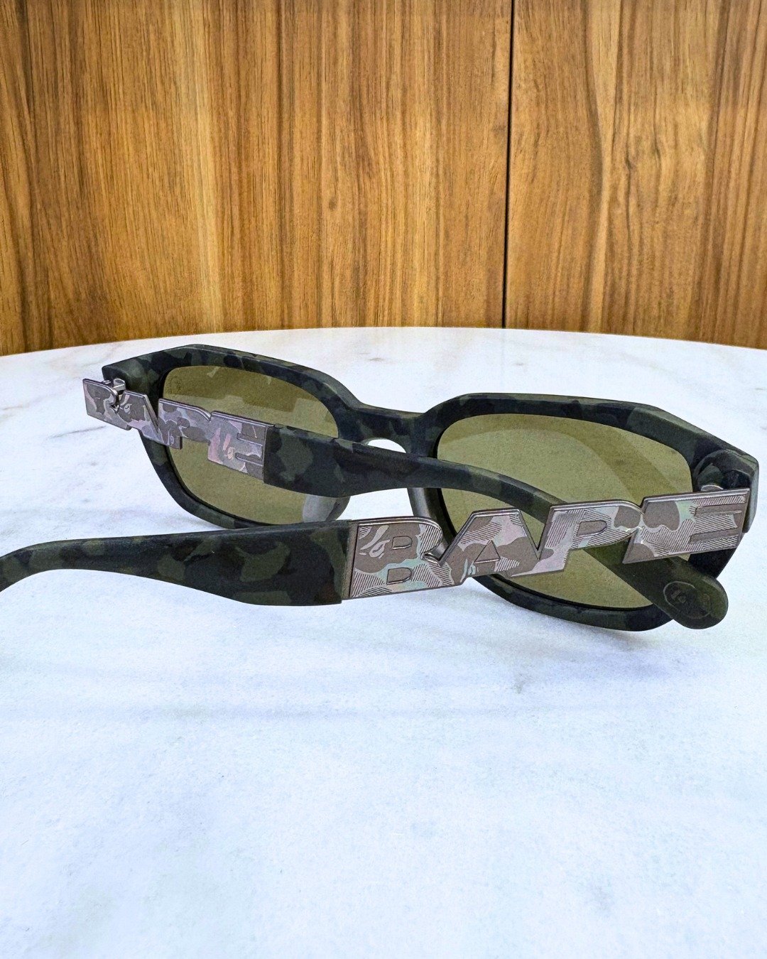 Not everyone needs basic frames. 

A Bathing Ape &mdash; black frame, green camo, dark smoke lens.
Angular hardware. Detail that earns its place. ✨

This is not a frame for blending in.
This is a frame for the person who was never going to.

At KIM'S