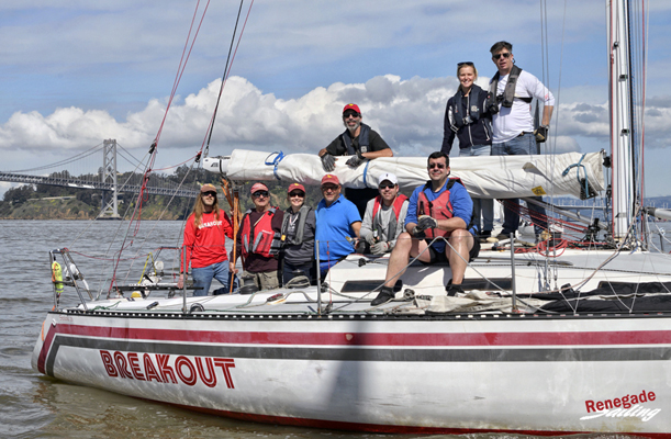 The crew on BREAKOUT, Santana 35 owned by Lloyd Ritchey, is ready for a photo.