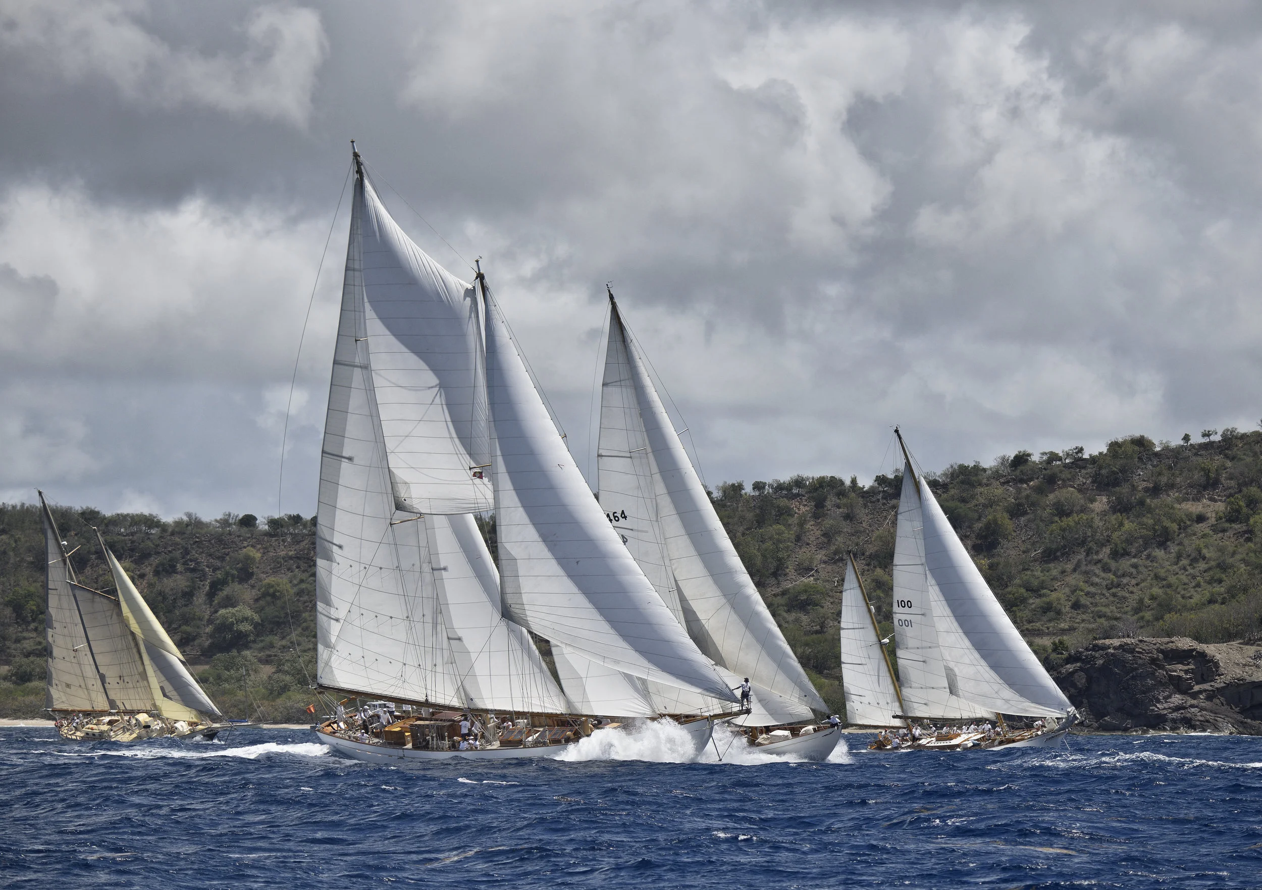 Long lens shot of the Antigua Classic Yacht Regatta, April 2018. In foreground is schooner Eros with bowman Wilson Willkom, aside is Mariella and Ticonderoga coming on strong.