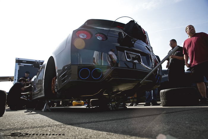 When he came back to the pits for the tuner to look over the datalog, he mentioned to the techs that the brake pedal did not feel as firm as he'd like them to be. The techs wasted no time and jacked the car up onto jack stands to bleed the brake system.