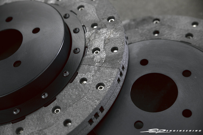 “ The third problem with carbon-ceramic brakes is they are brittle and this a very delicate surface. The surface on carbon-ceramic brake rotors are so delicate if you let your wheel hit the rotor when changing tires or you go off road during a track day and gravel or even small rocks hit and chip the rotor is must be replaced at great expense. Because RPS’s entire carbon-carbon brake rotor is nothing but pure carbon molecules with no candy-like surface, dropped wheels and rocks will not damage the rotor to the point of replacement which is exactly why most all racing series make competitors remove their carbon-ceramic rotors and replace then with either steel or real carbon-carbon before being allowed to race. ” – RPS Carbon Technology
