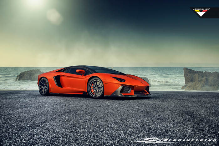 Exciting news we have received this week! We are very excited to be the first to announce and introduce Vorsteiner’s newest hot item for the Lamborghini Aventador – Zaragoza front fascia. They also released their Active-Aero Wing since it’s introduction at SEMA last year. The Zaragoza front fascia will be made with pre-preg carbon fiber in a 2×2 gloss twill weave. Both pieces have been in the works for a long time now, and it is wonderful to see more love going towards the Aventador chassis. The ability to design the wing to work just as the OE is a testament of Vorsteiner’s capabilities. For those of you as excited as us about these new products, SP Engineering is now accepting pre-orders. As a distributor for Vorsteiner, we are excited to be the first to offer the Zaragoza front fascia and Vorsteiner Active-Aero Wing for the Aventador. All mentioned parts are made as pre-preg carbon fiber in a 2×2 gloss weave. Zaragoza Front Fascia – $5,700 Zaragoza Front Fascia w/ V-Aero Kit – $20,500 Above w/ optional OE Carbon Fiber – $27,600 V-Aero Kit will include: – Side Skirt Extensions – Rear Diffuser – Active-Aero Rear Wing Blade w/ Carbon Fiber Up-Rights (Uses factory strut functionality. One and only in the world to do so) OE Exterior Parts include: – Front Bumper Grill Frame (Right & Left) – Hood Vent Trim (Right & Left) – Side Air Scoop (Right & Left) – Rear Bumper Grills (Right & Left)