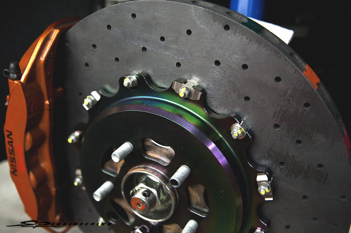 When I mentioned this was Joshua’s toy, I really meant it. His first mod with us was this Stillen carbon ceramic brake kit that will have your face smashed into the steering wheel under hard braking. What’s so great about carbon ceramic rotors? They look cool (looking cool is important), they’re light as hell, they’re bigger (400mm) and they look cool…