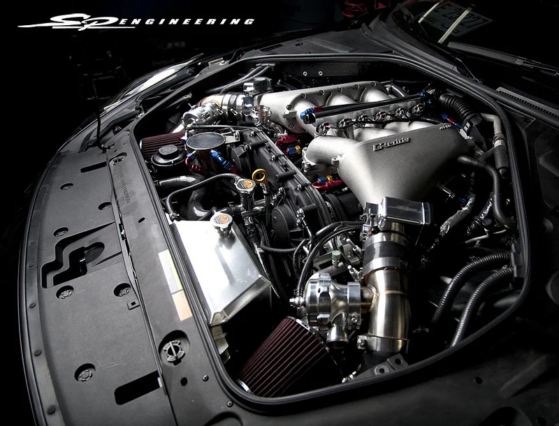 Once all the custom work is done and ensured to meet our standards, the external parts of this motor’s build are properly installed. These items include: - SPE GODZILLA Turbo System – SPE Spec Custom Manifolds – SPE Spec V-Band Turbochargers – SPE Spec V-Band External Wastegates – SPE 76mm Down Pipes – SPE Spec ETS Race Intercooler System – SPE Spec Greddy Aluminum Intercooler Pipe Kit – SPE Spec Greddy Blow Off Valve System – SPE Spec Air Suction Pipe Kit 90mm – SPE Spec Greddy Fuel Rail – SPE Spec Intake Manifold – SPE Spec Additional Fuel Rail – SPE Spec 75mm Throttle Body – SPE Spec 3000cc Injectors – SPE Spec AAM Fuel Pump System – SPE Spec Race Fuel Pressure Regulator + Gauge – SPE Spec Oil Catch Tank – SPE Spec Titanium 4” Exhaust System – SPE Spec Racing Spark Plugs Range 9 – ATI Crank Damper