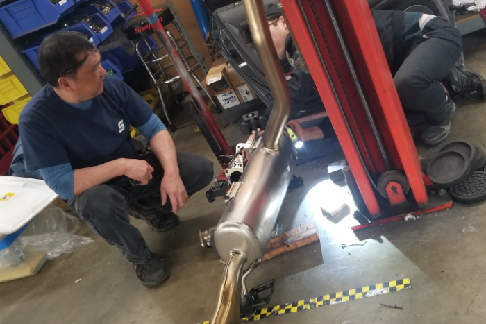Kristian and Howard taking a look into the exhaust design after removing the valvetronic pipe section on the OEM Exhaust. 