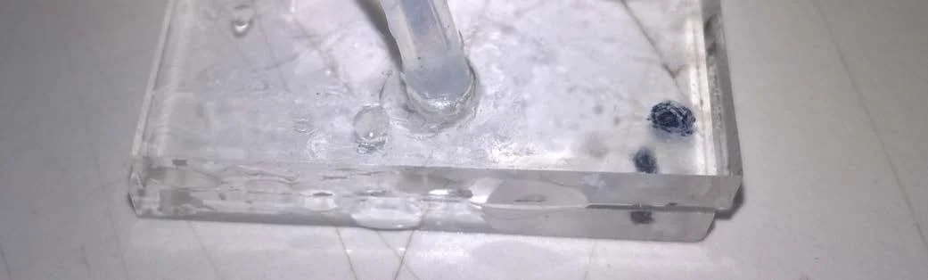 Figure 9: Prototype Microfluidic chip, leakage of liquid between top and bottom components when sealed with superglue.