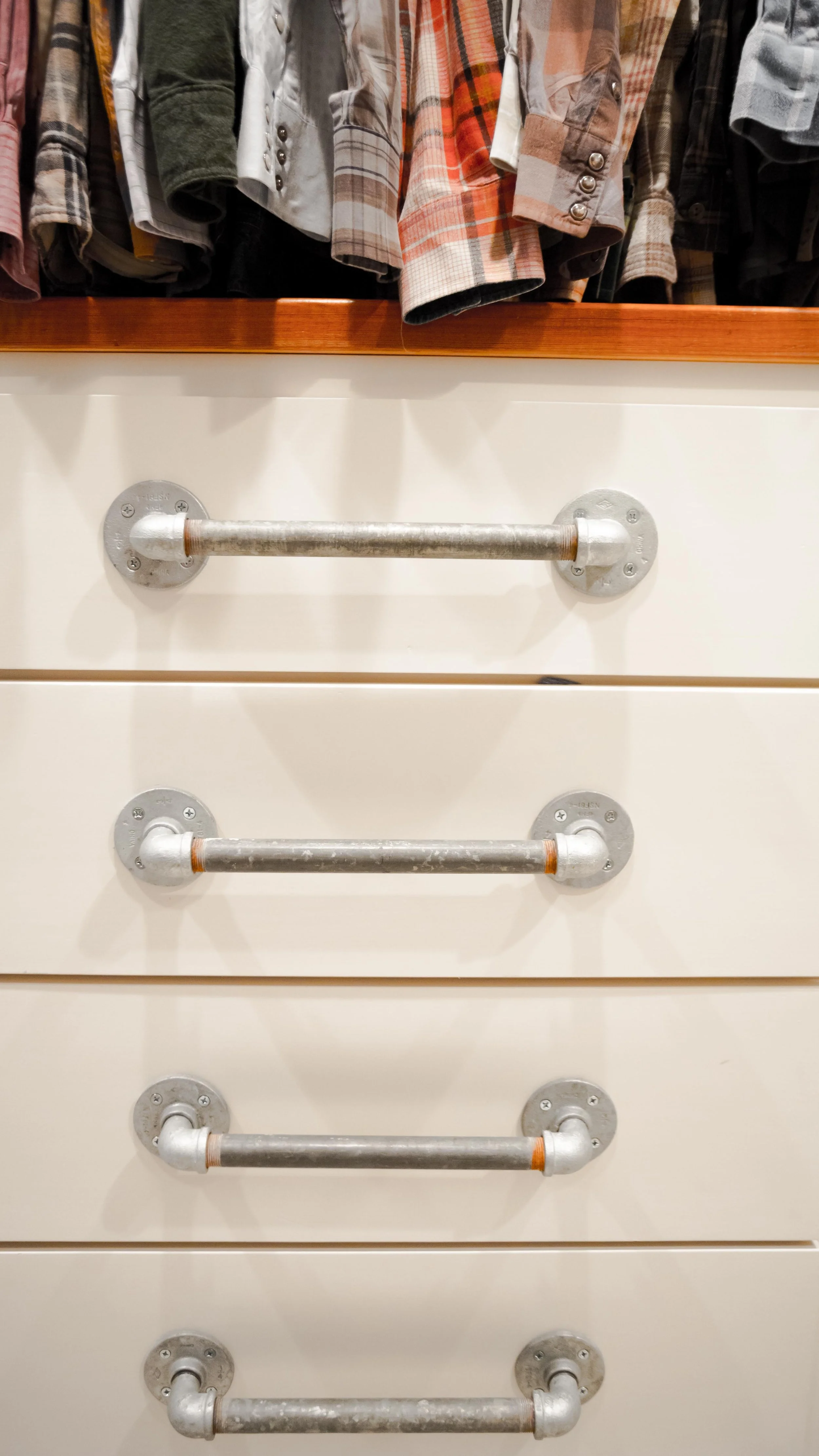 Repurposed pipe fittings used for cabinet hardware