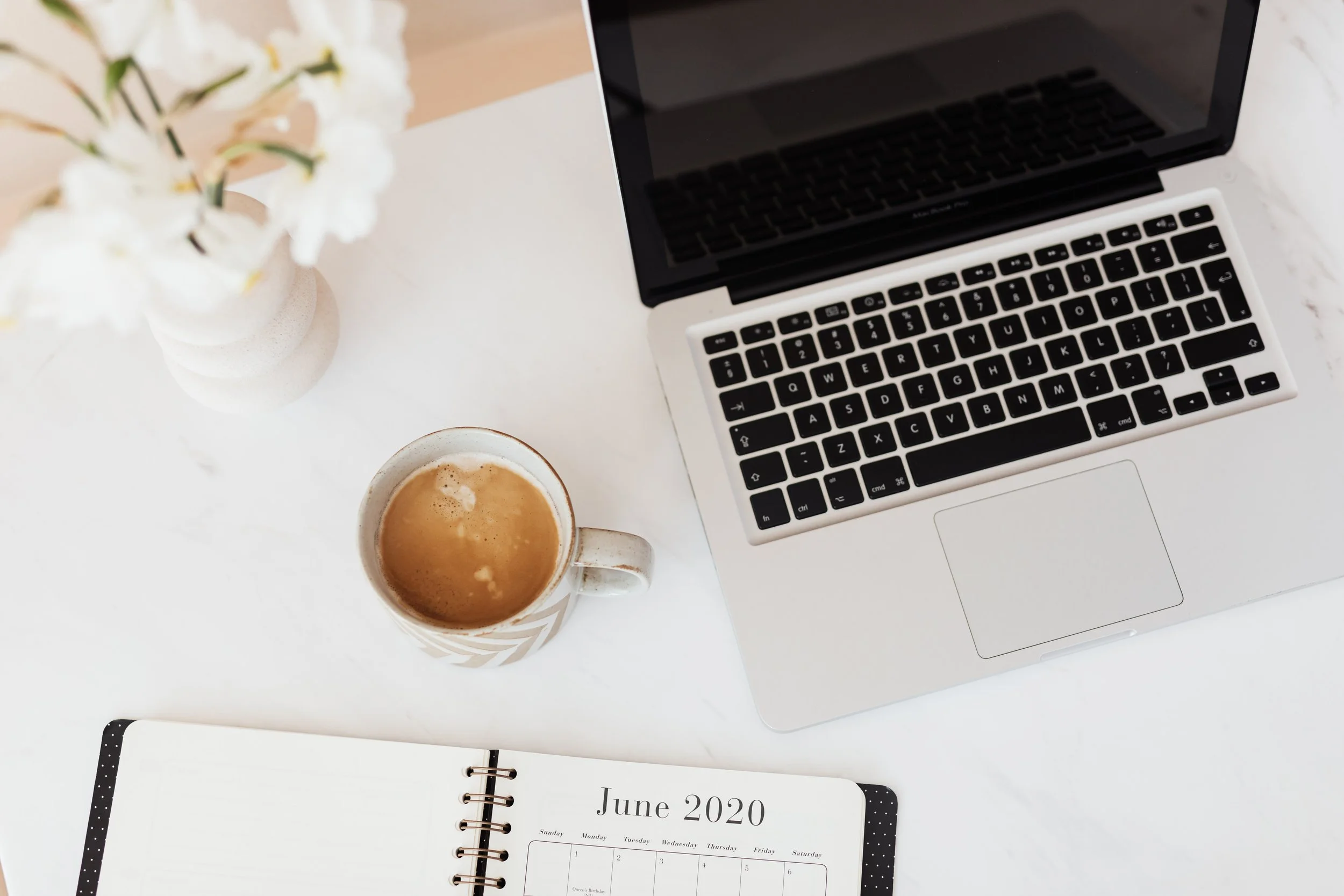 kaboompics_Laptop - white flowers - organizer & cup of coffee on marble table.jpg