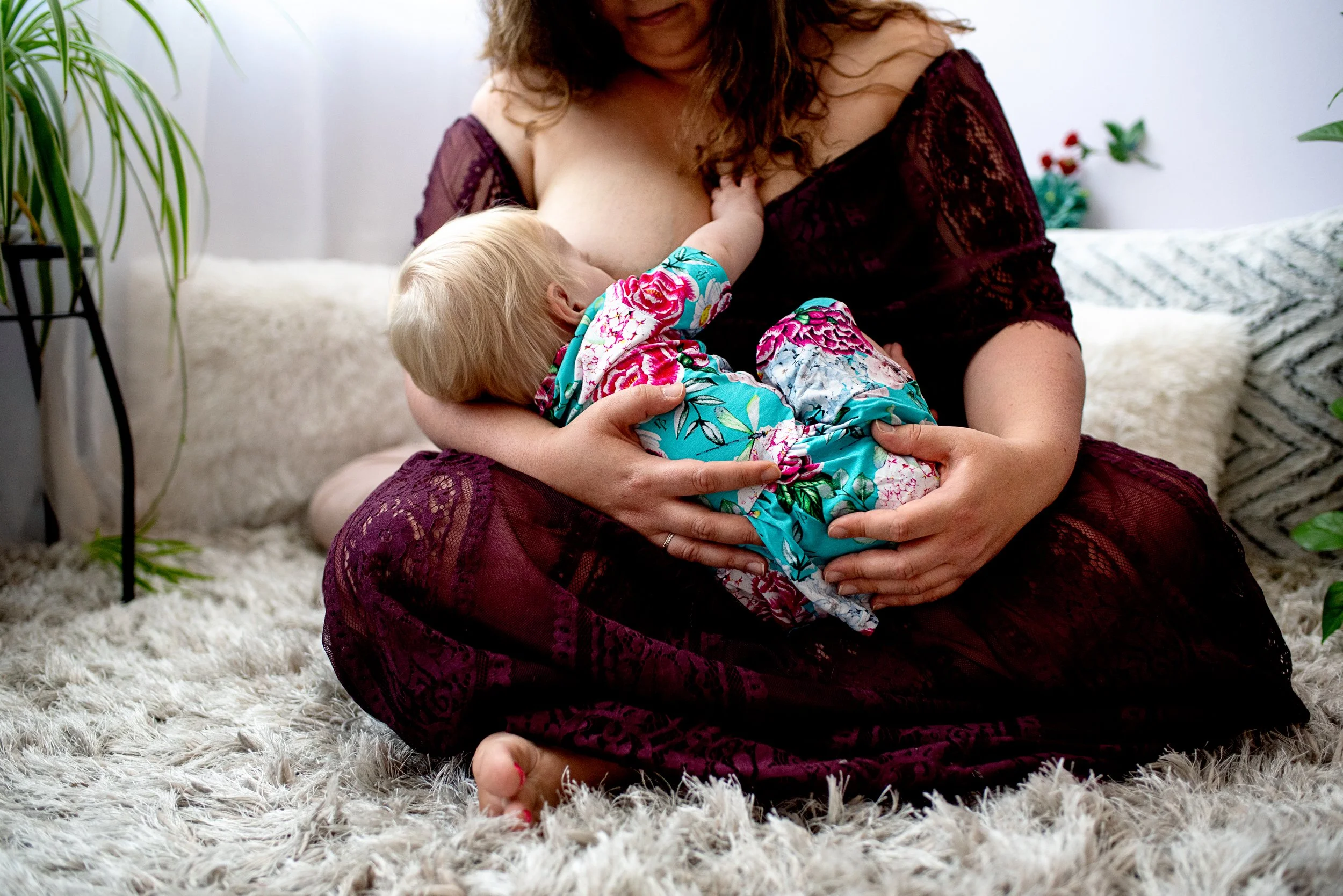 mom nurses her baby in a lifestyle studio photo session