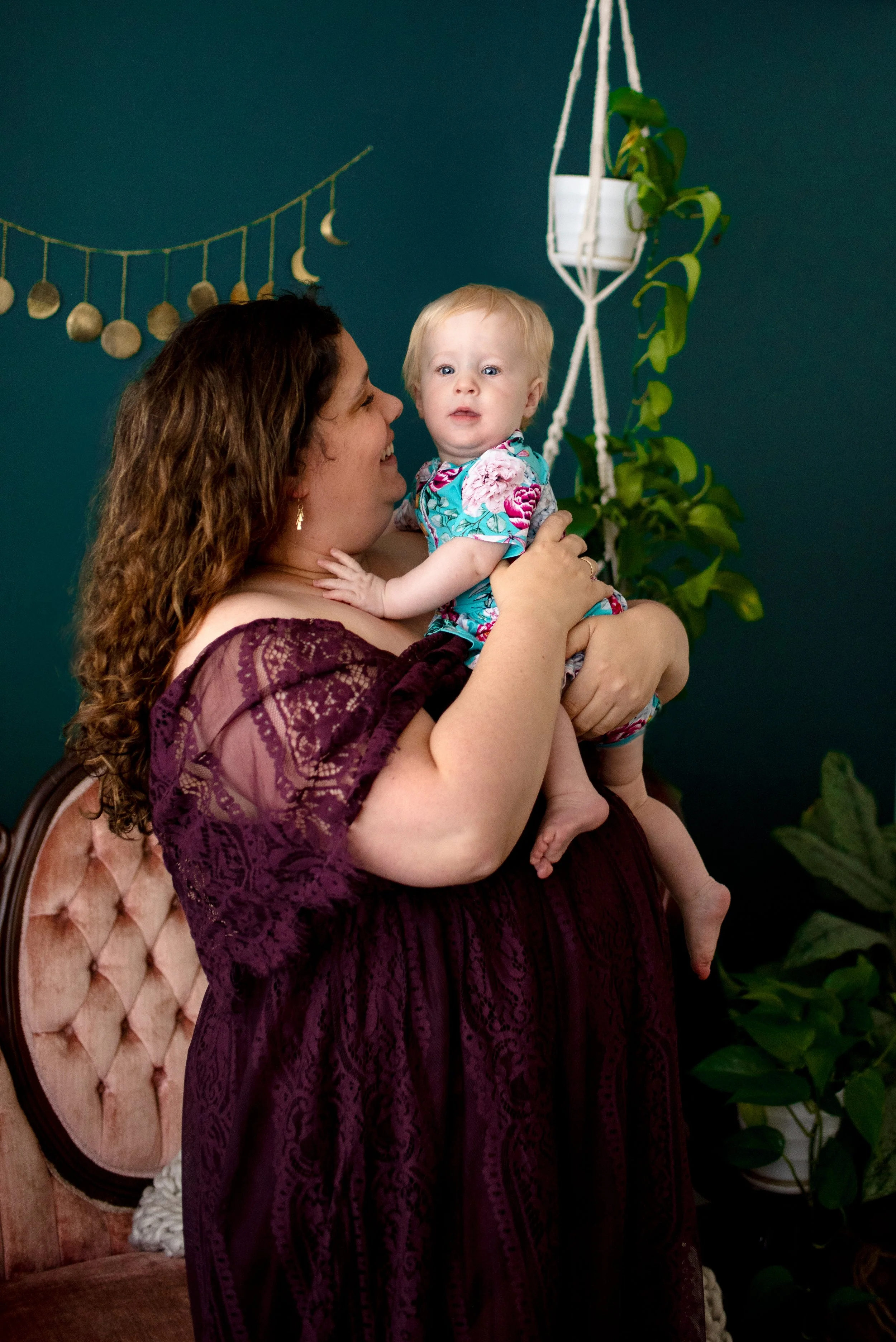 happy mom holds child for portrait