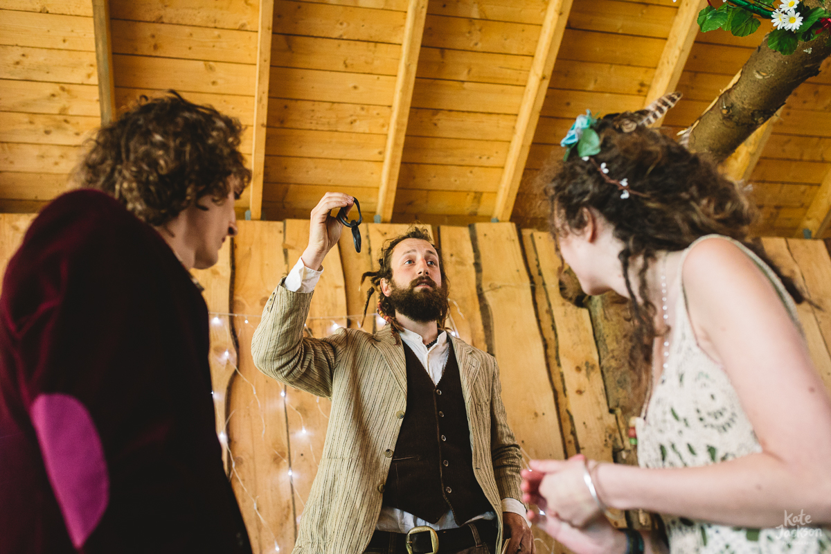 Humanist blacksmith festival wedding ceremony, the celebrant is holding a piece of chain link up during the wedding ceremony.