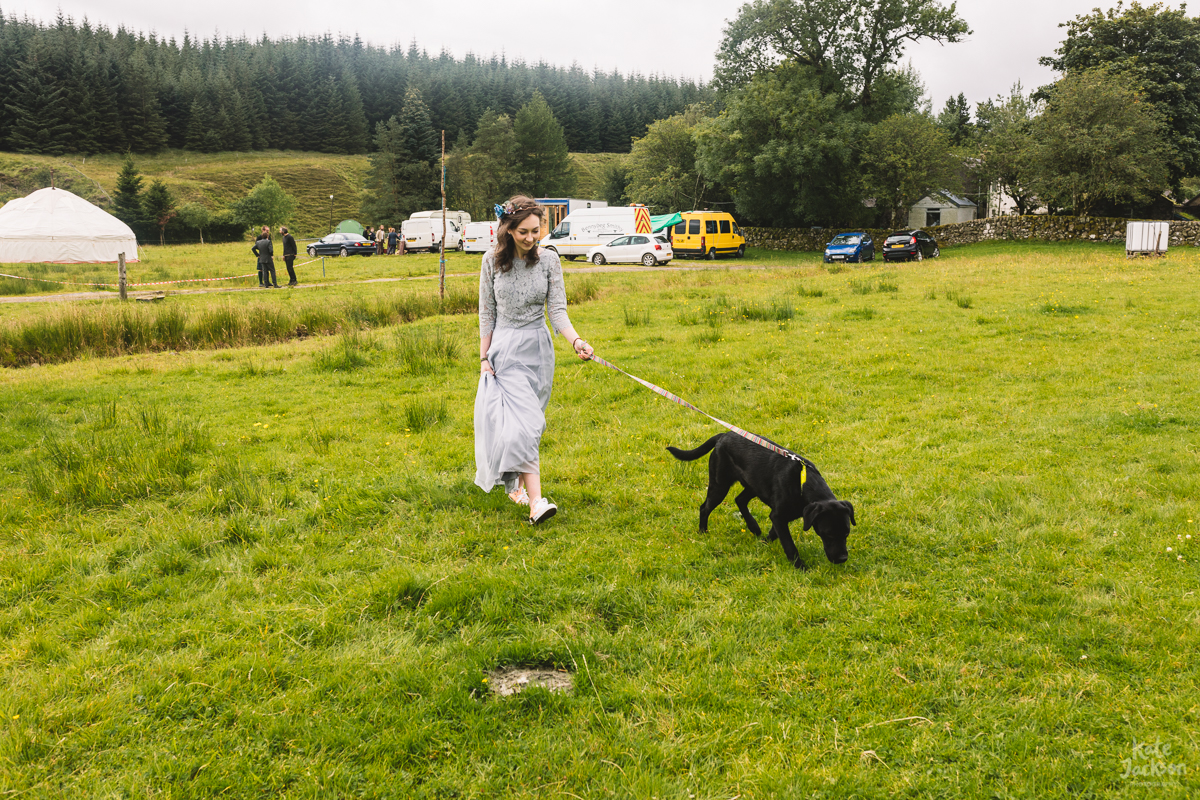 Bridesmaid in a two piece and cute dog at DIY festival wedding | Kate Jackson Photography