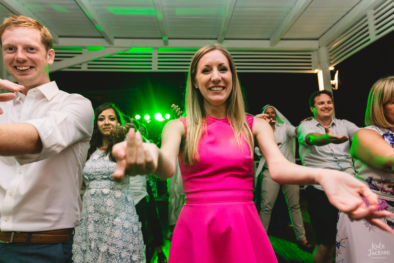 Fun macarena dancing at beach wedding in Skiathos