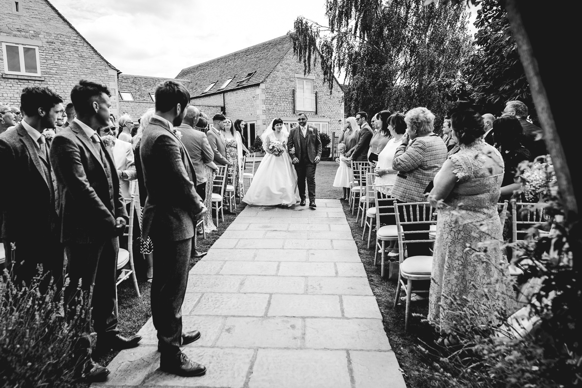 Bride in Vintage Lace Dress Walking Down Aisle at Hyde Barn