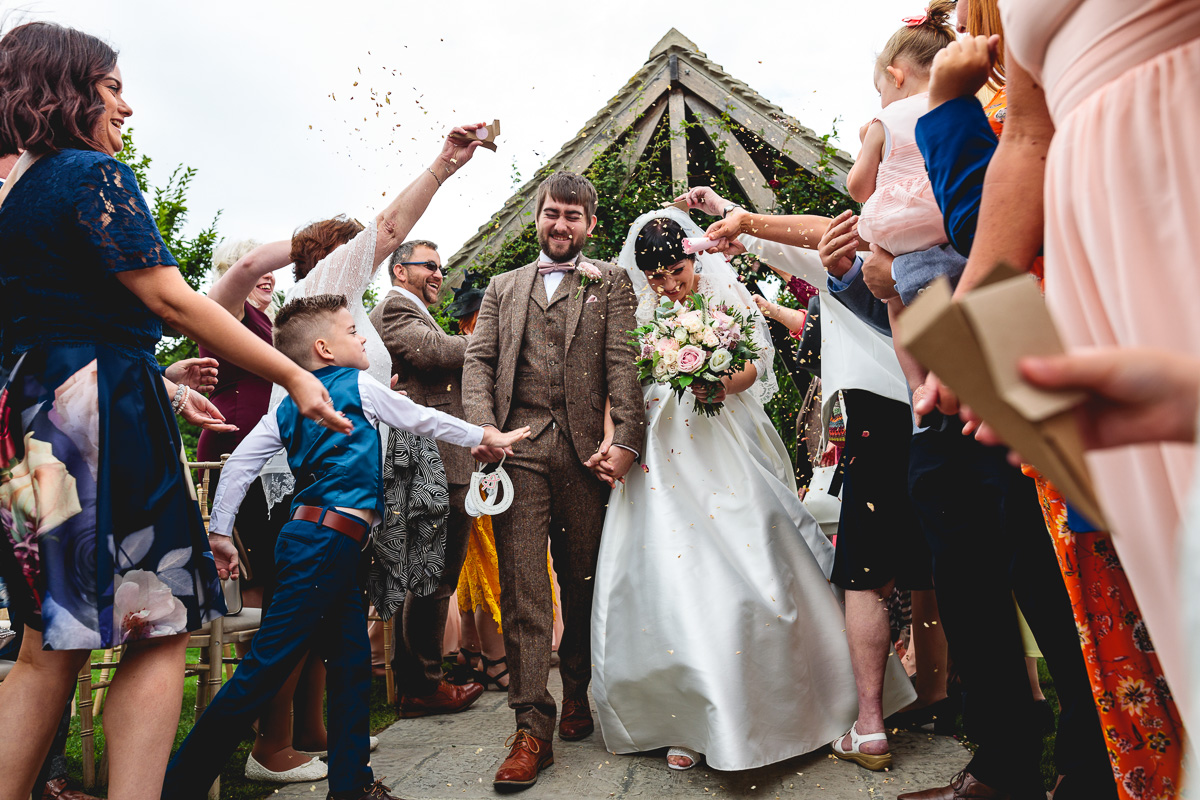 Fun confetti photo at summer outdoor wedding