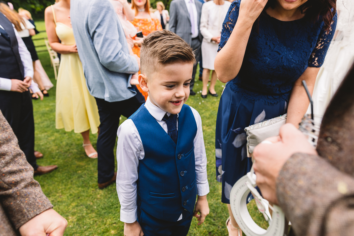 Page boy gives groom horseshoe at Outdoor Hyde Barn Wedding