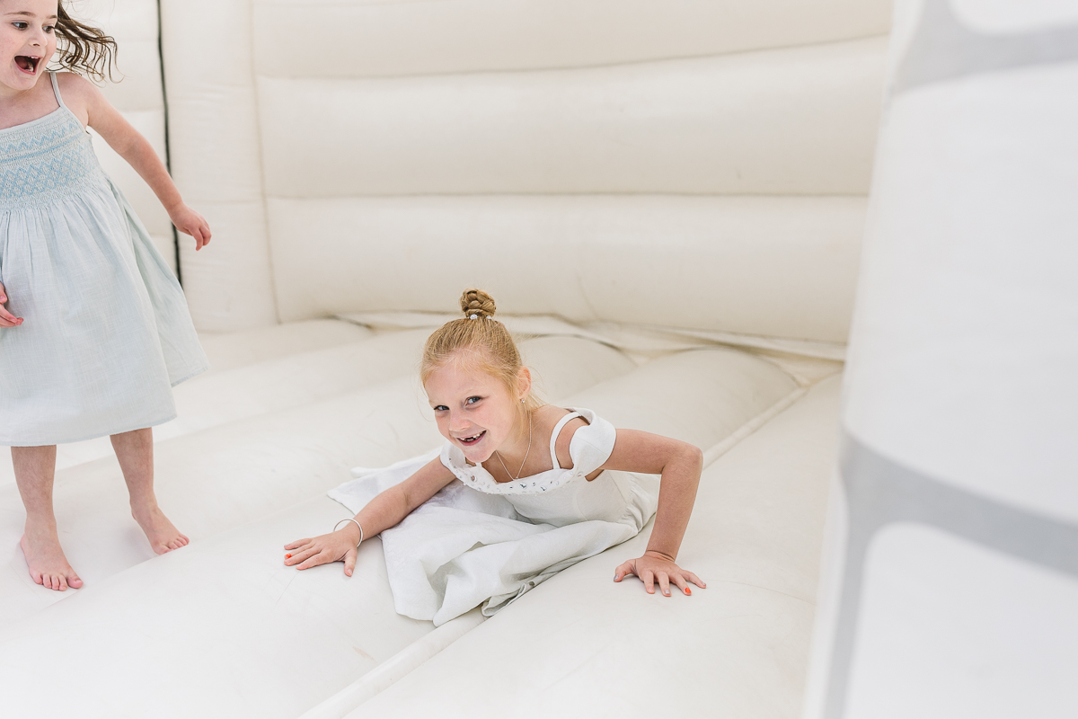 Fun and Laughter on the white wedding bouncy castle