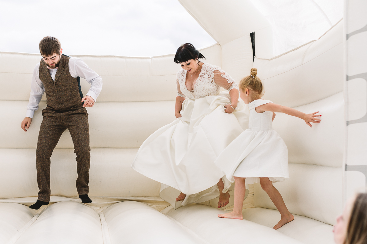 Hyde Barn Weddings Bouncy Castle with Bride having fun