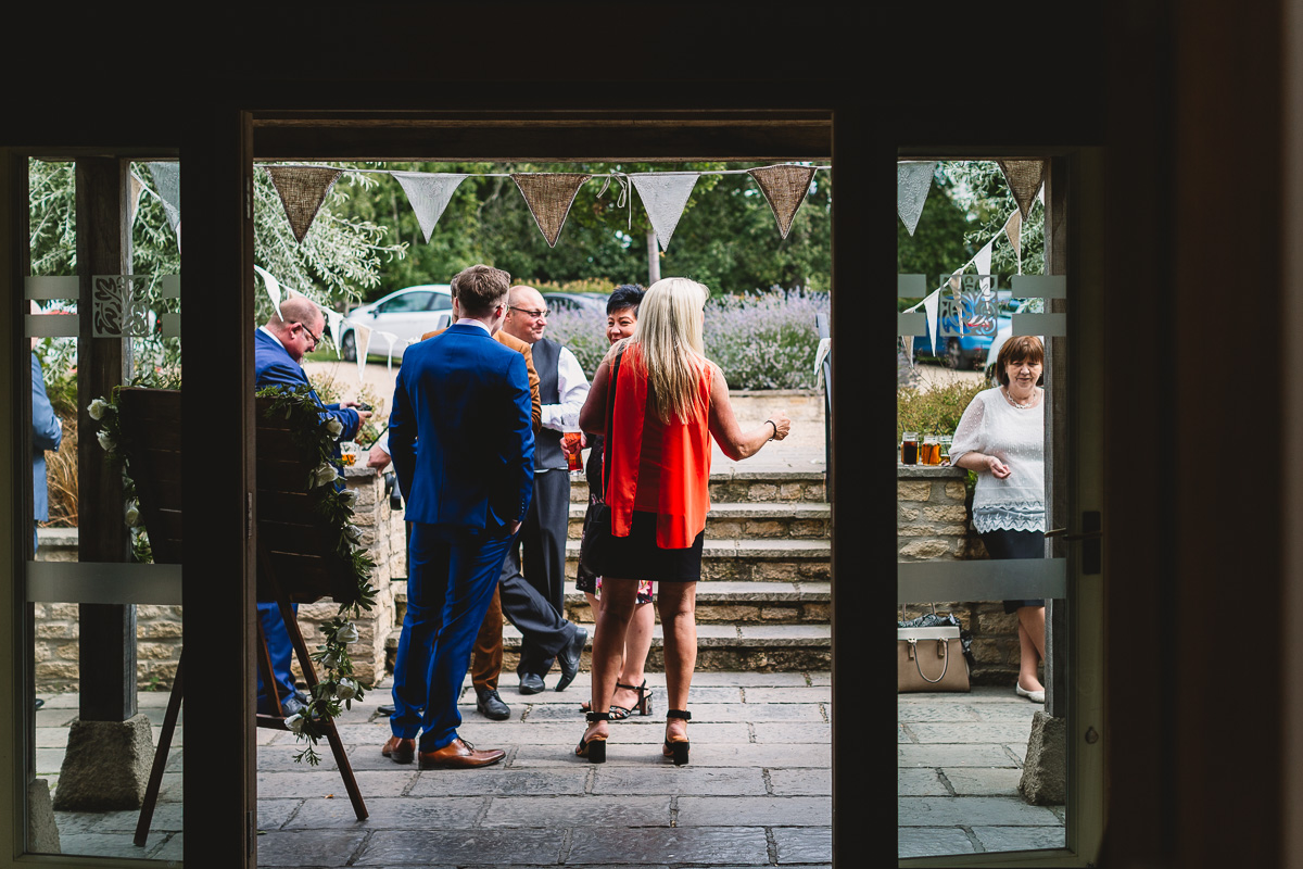 Documentary Wedding Photo of people standing outside at Hyde Barn Weddings