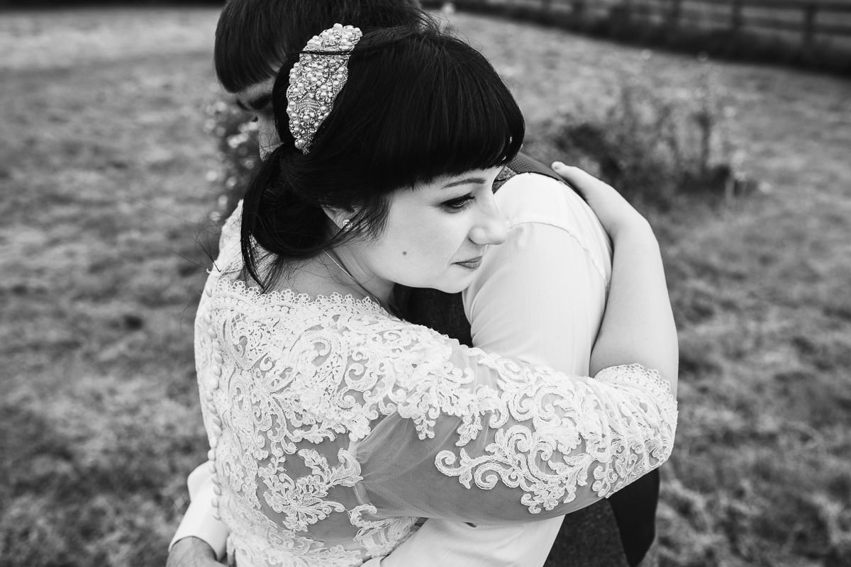 Romantic and natural couple embrace at Hyde Barn Weddings