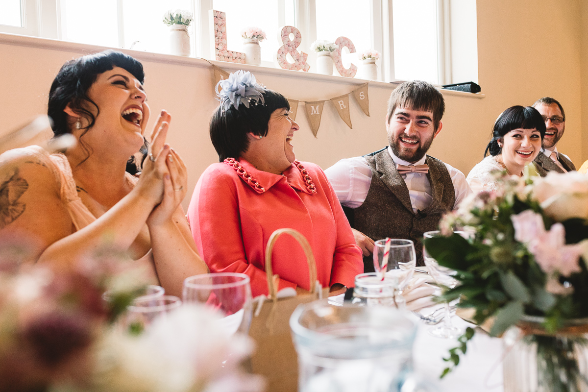 People laughing during funny wedding speech | Cotswolds Hyde Barn