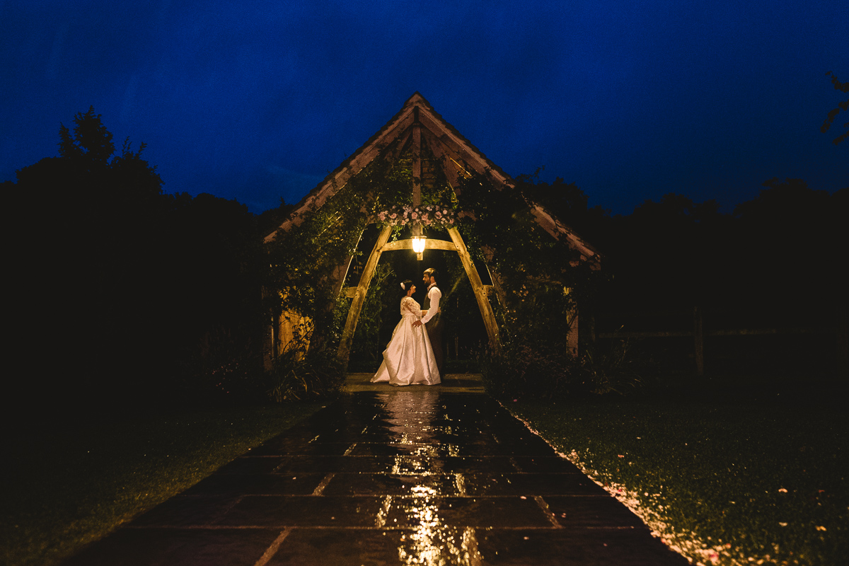 Bride and Groom standing under awning at Hyde Barn | Natural Wedding Photographer