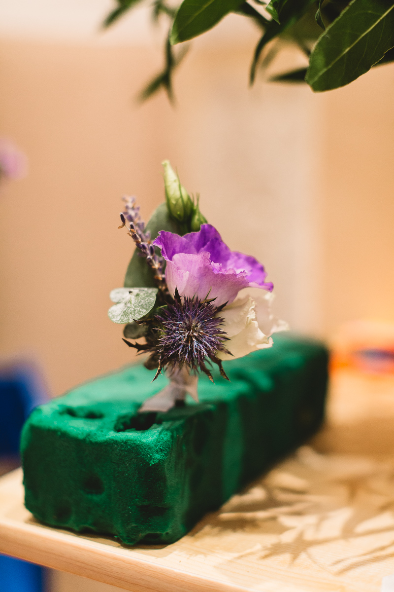 Boho purple buttonhole with thistle at relaxed france wedding