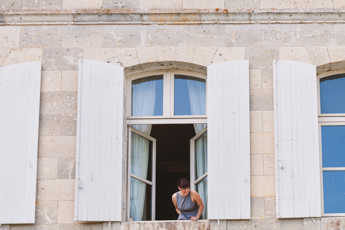 Fun bridesmaid hanging out of window at Chateau Lasfargues wedding
