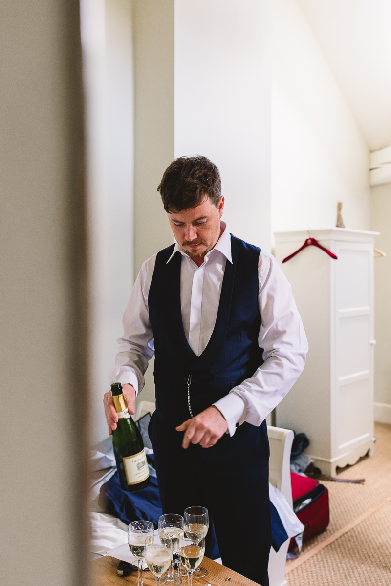 Fun groom prep drinking champagne at chateau wedding