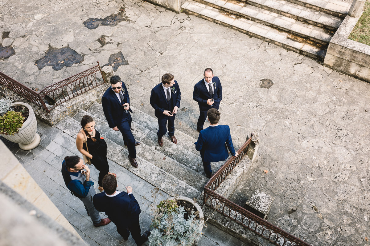 Groomsmen in blue suits on chateau terrace at france destination wedding
