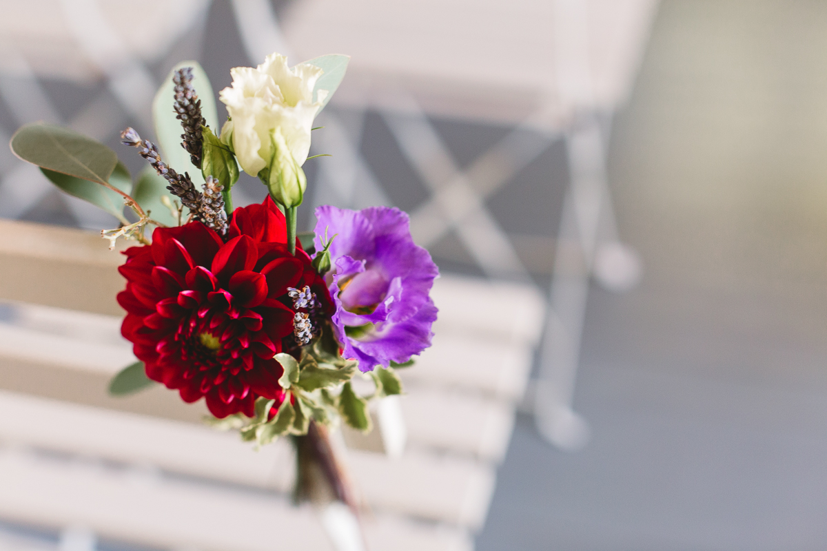 Rustic flowers on ceremony chairs at france destination wedding