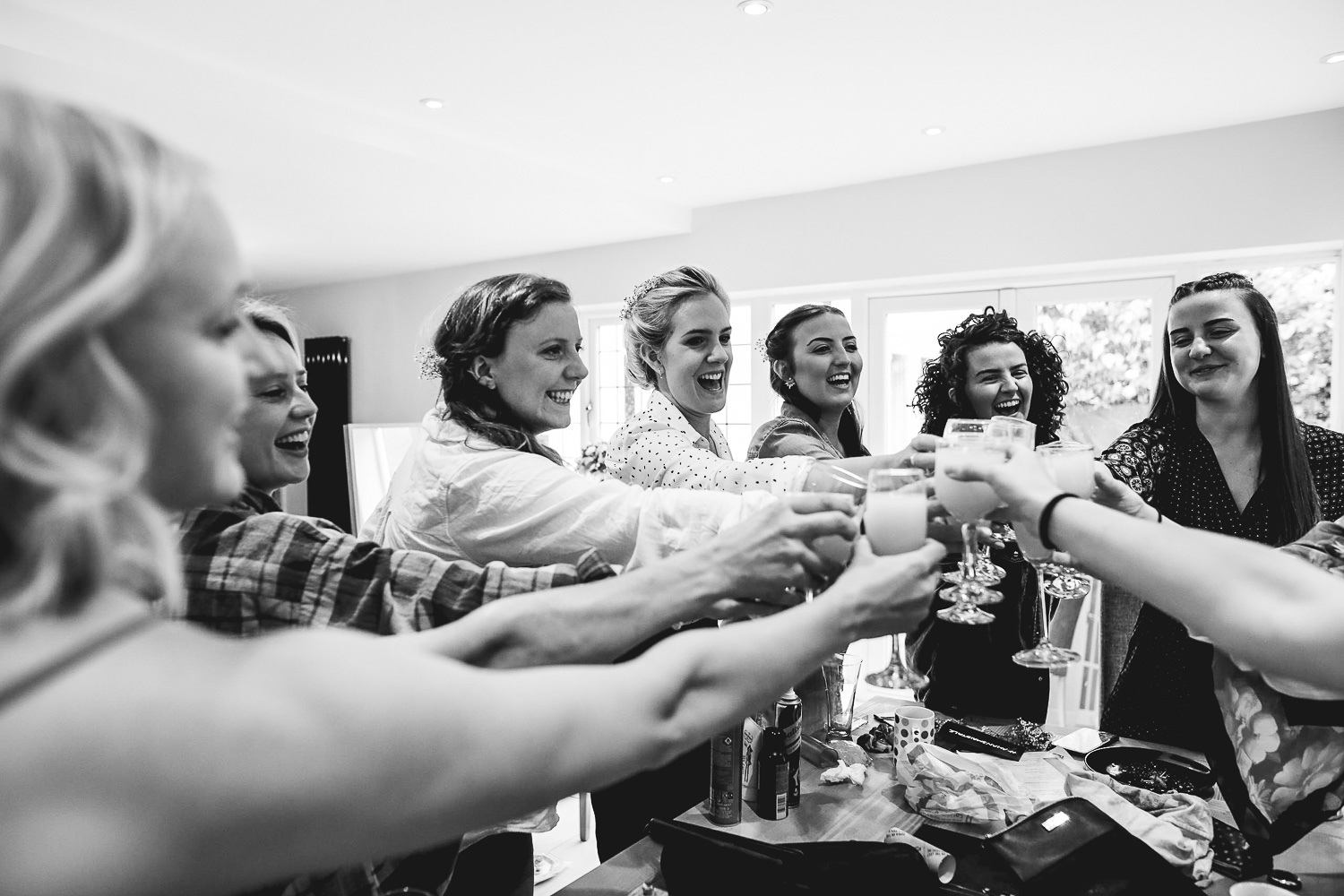 Photo of bridal party cheersing at relaxed Sheffield wedding