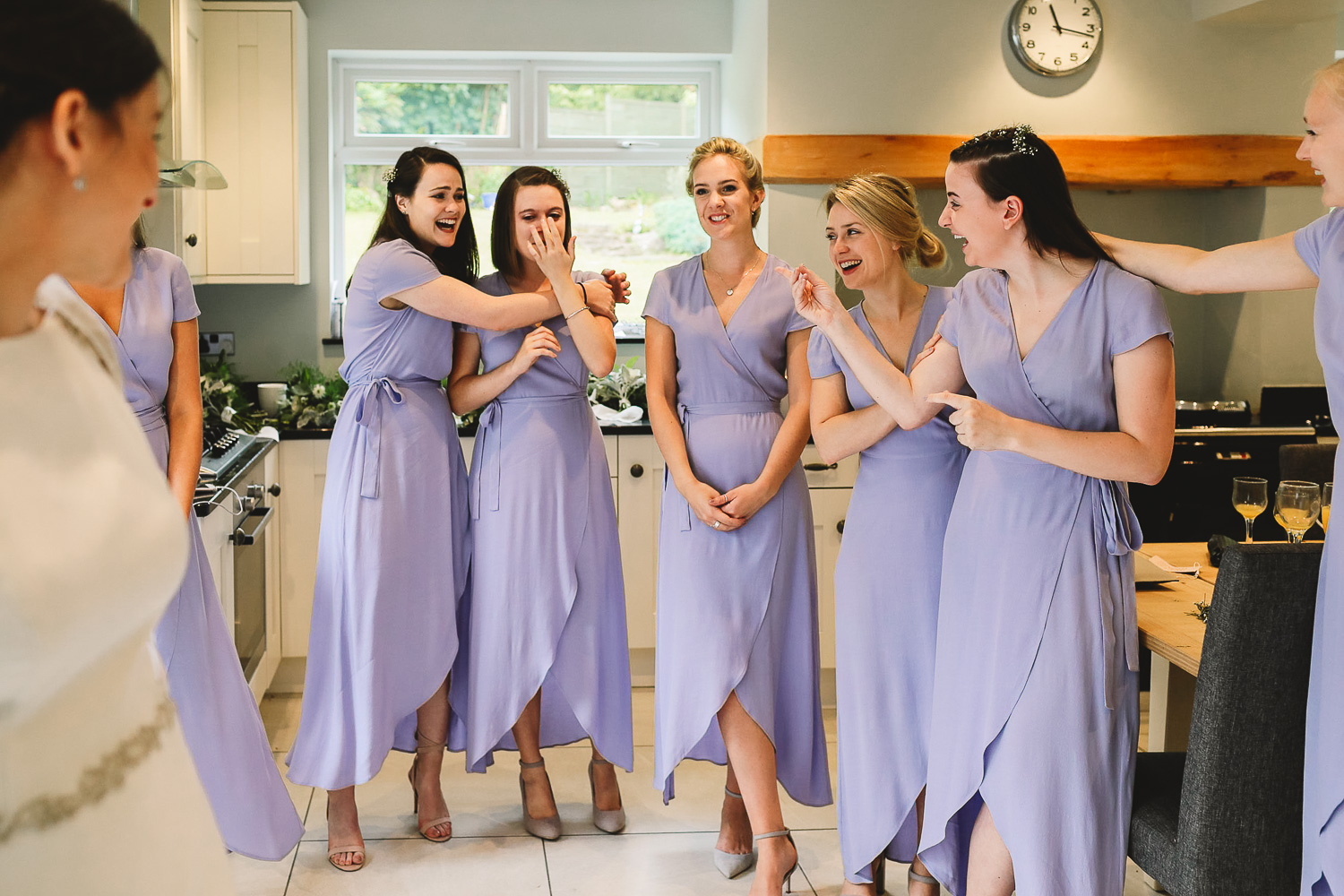 Bridesmaids in lilac &amp; other stories dresses see bride for the first time and cry and laugh at the same time during bridal prep in Sheffield