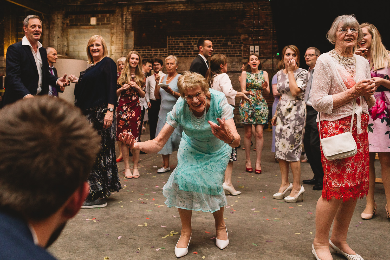 Granny in mint green dress having a boogie at fun wedding party at alternative warehouse wedding venue 92 burton road