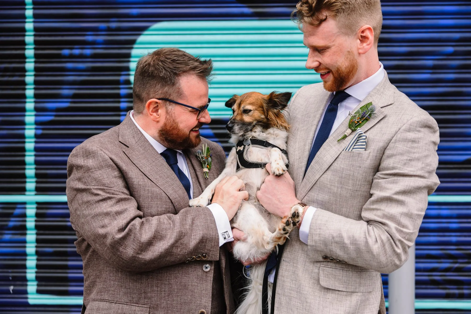 Two grooms laughing with their dog during relaxed wedding couple photos  at Fazeley Studios