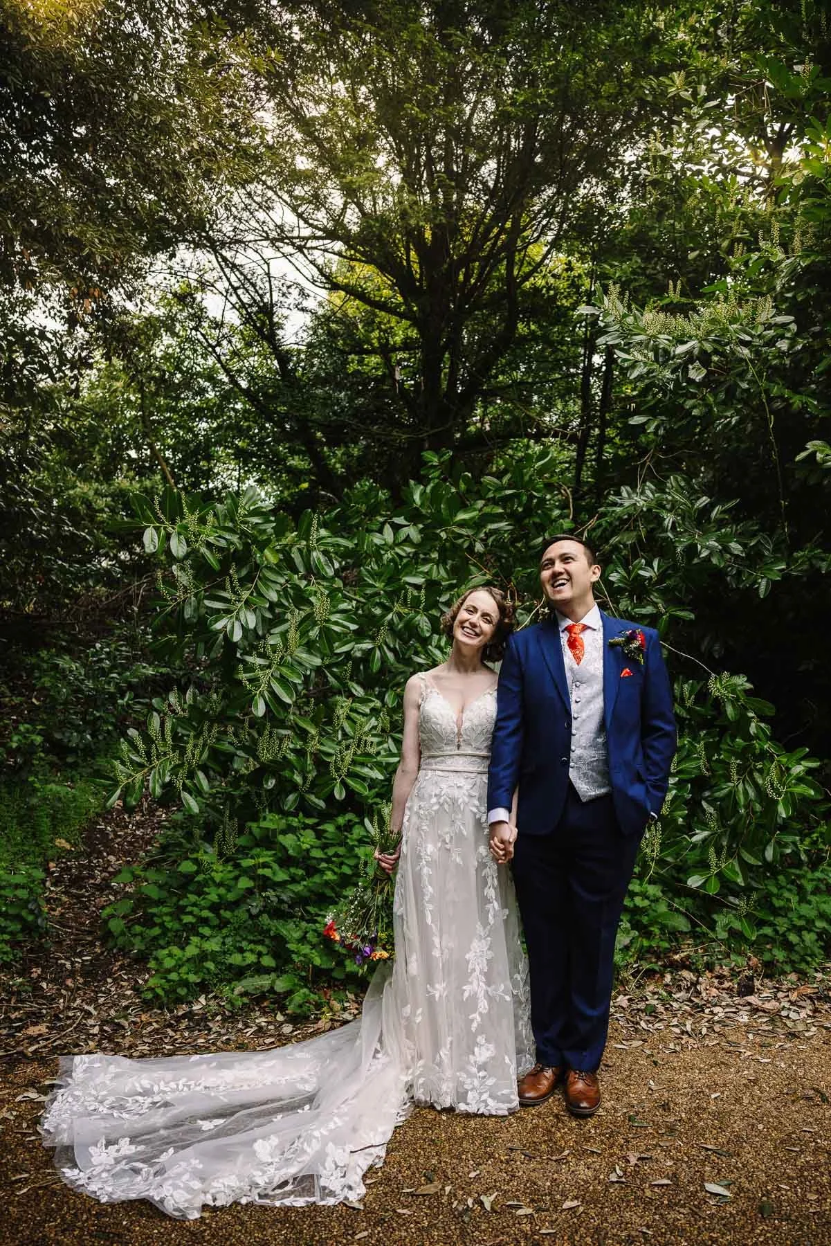Bride and groom laughing together in the gardens at Highbury Hall on their Birmingham wedding day