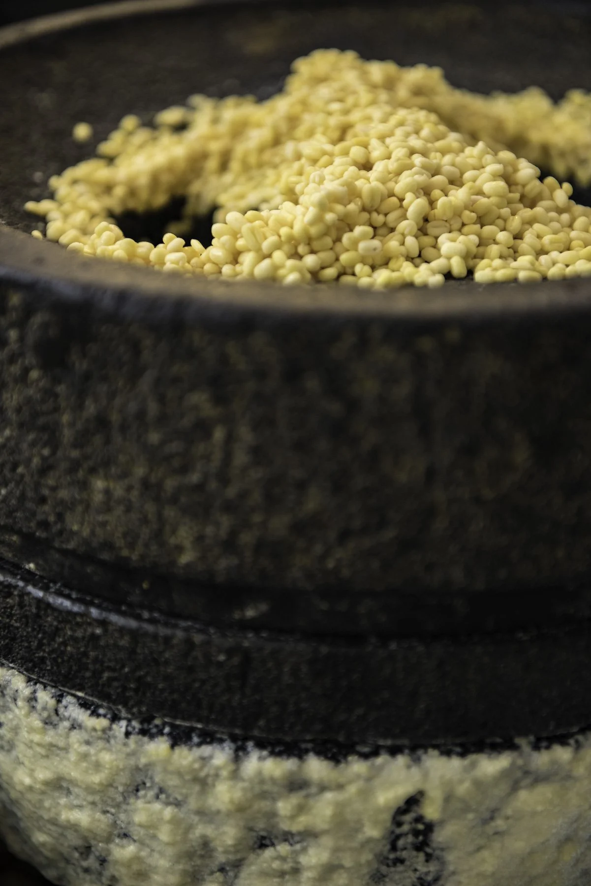 Close-up of millet being toasted in a cast iron skillet.