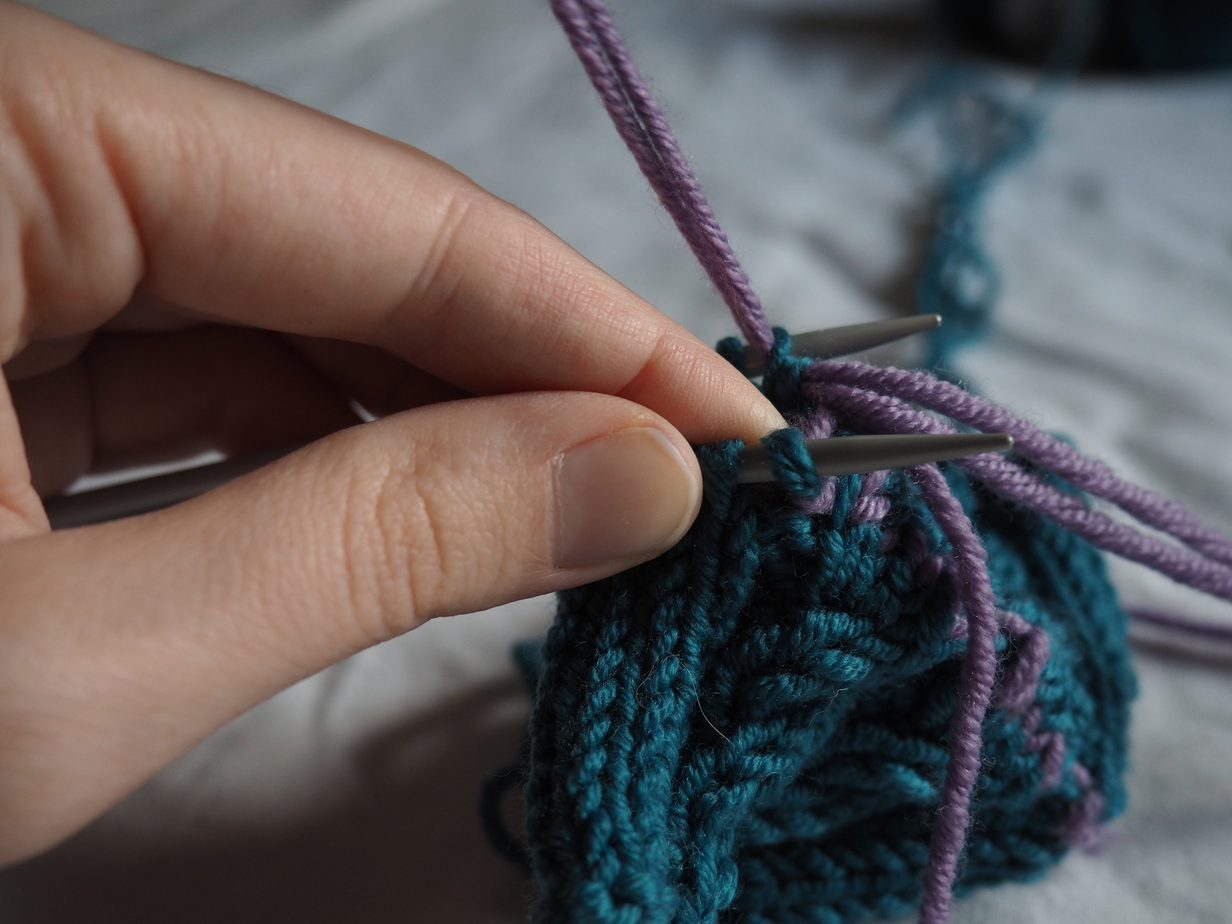 thread the yarn purlwise into the 2nd stitch.