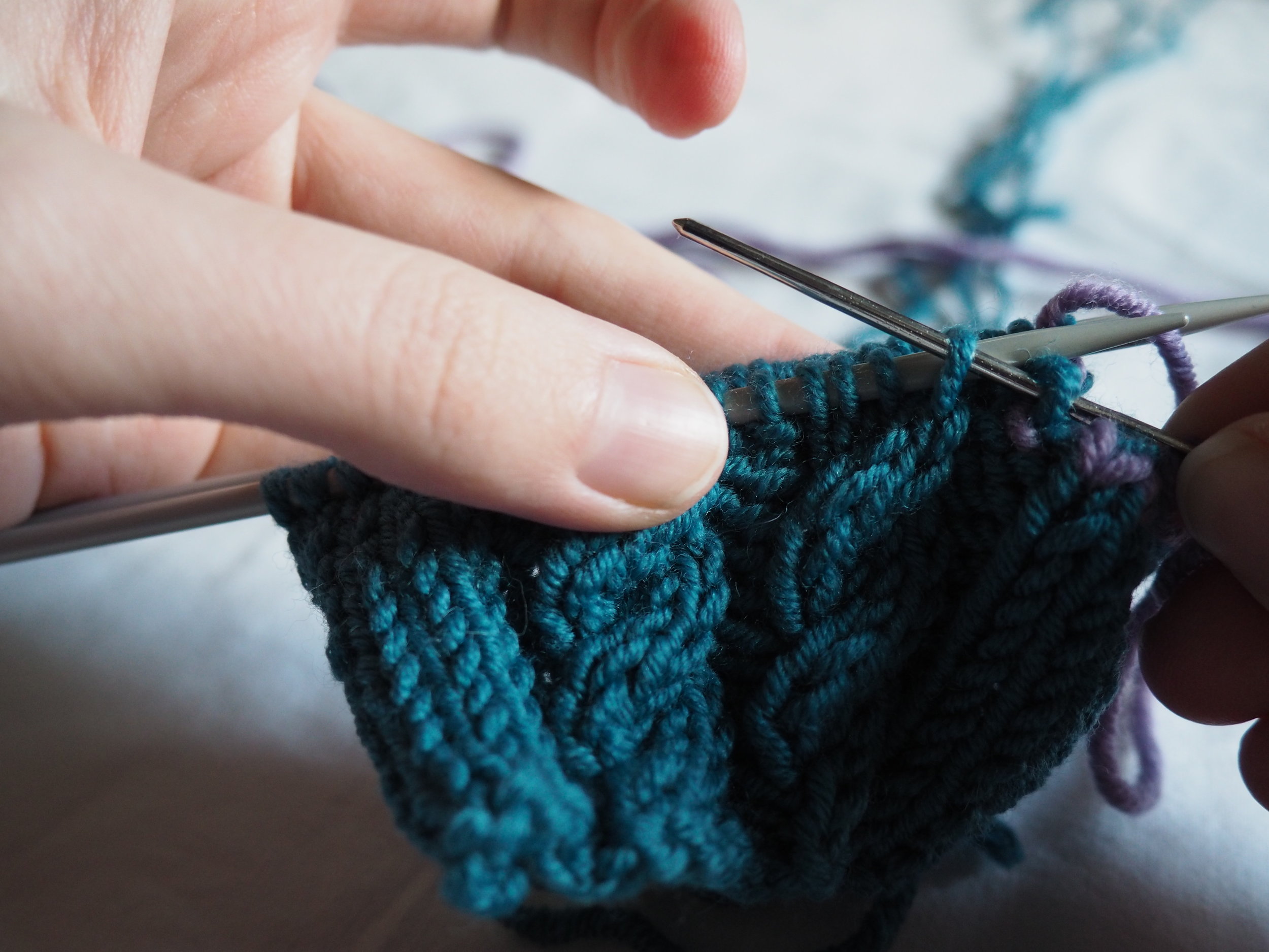 thread the yarn purlwise into the 2nd stitch.