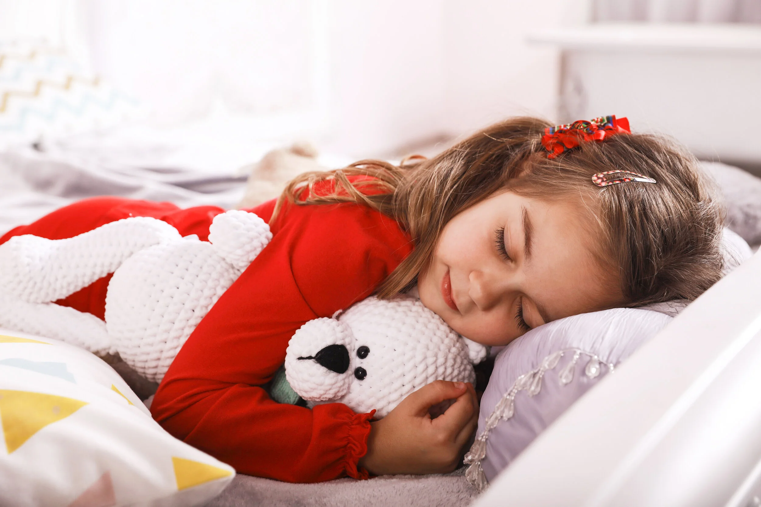 cute-small-girl-is-sleeping-with-white-bear-toy-dressed-in-the-red-pajamas.jpg