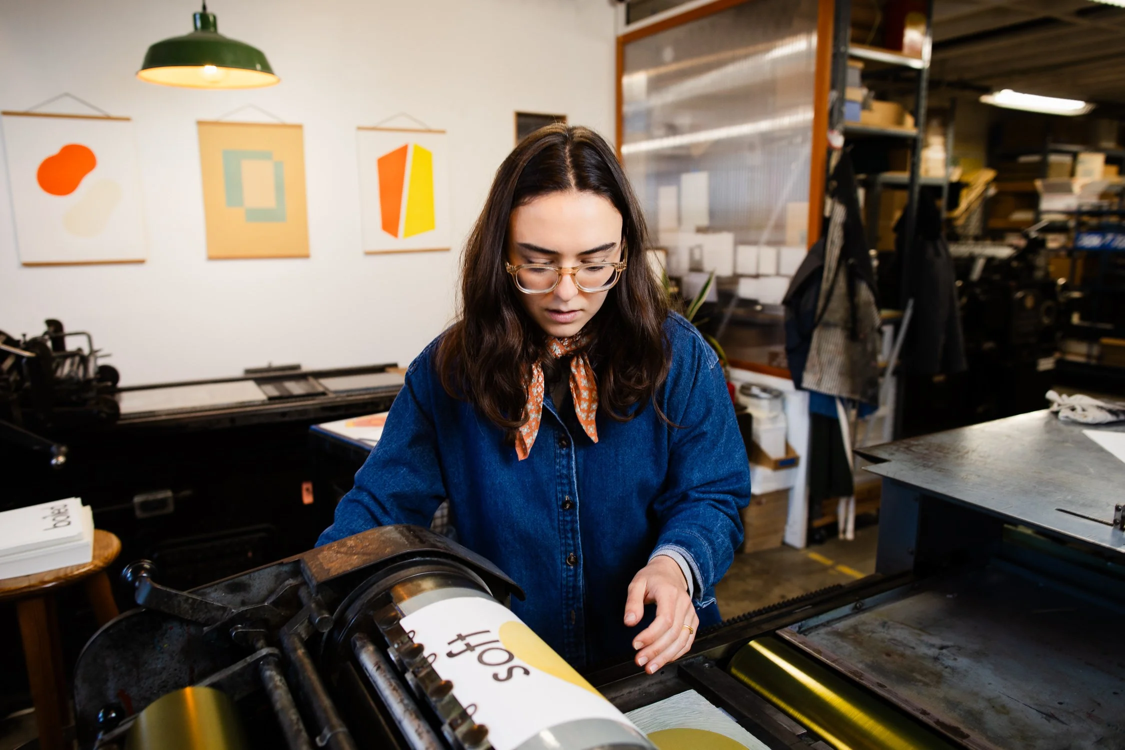 Small business owner operating a printing press at Aesthetic Union, captured during a brand photography session in San Francisco