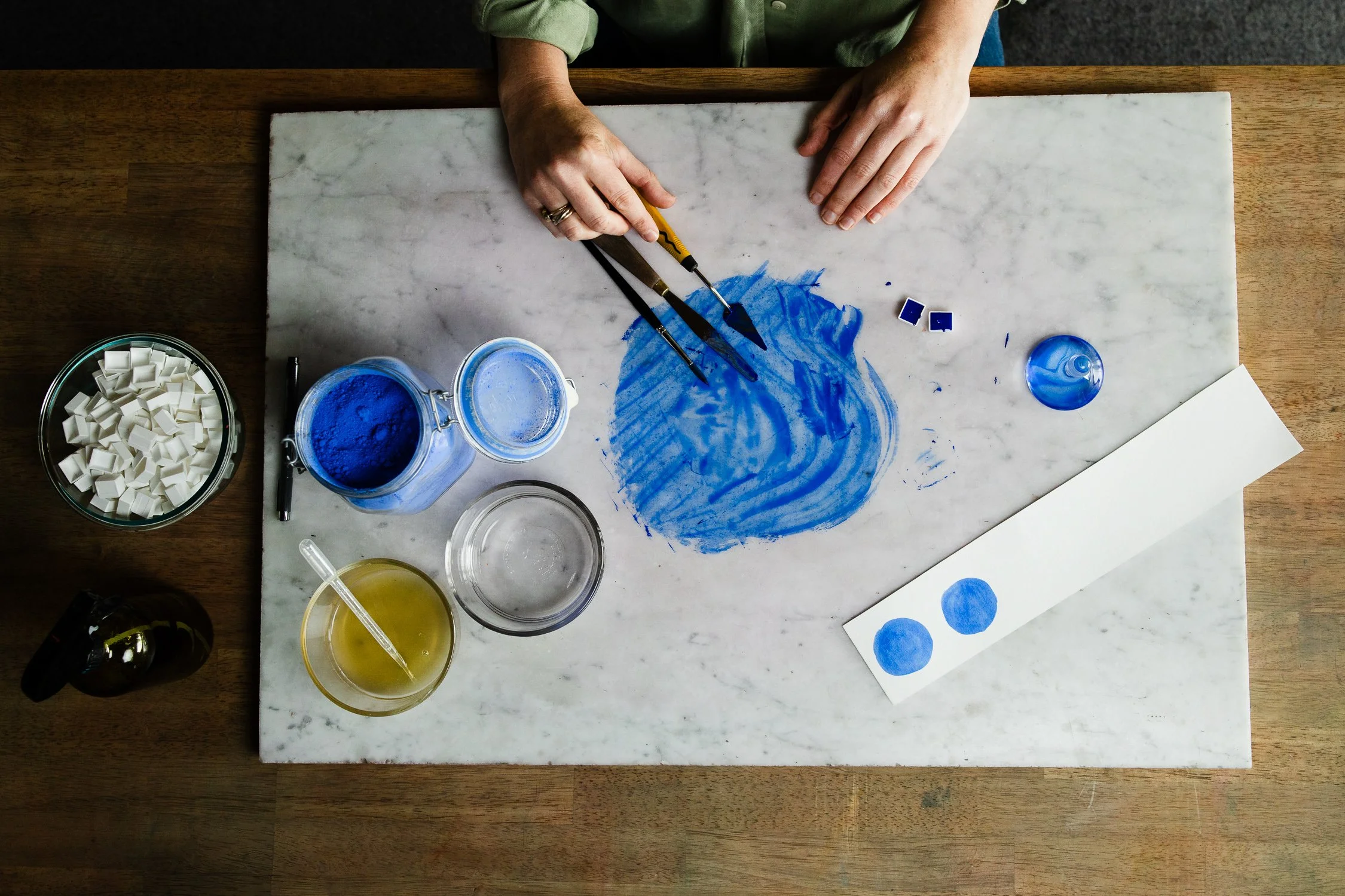 Hands of Alexis Joseph creating cobalt blue watercolor paint, process detail from San Francisco brand photography session