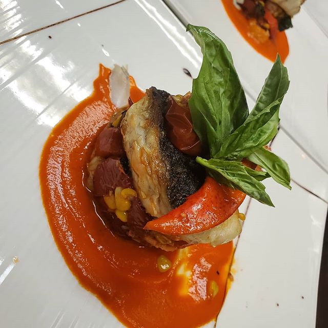 Barramundi napoleon with roasted try colors chrery tomatoes with lobster an basil