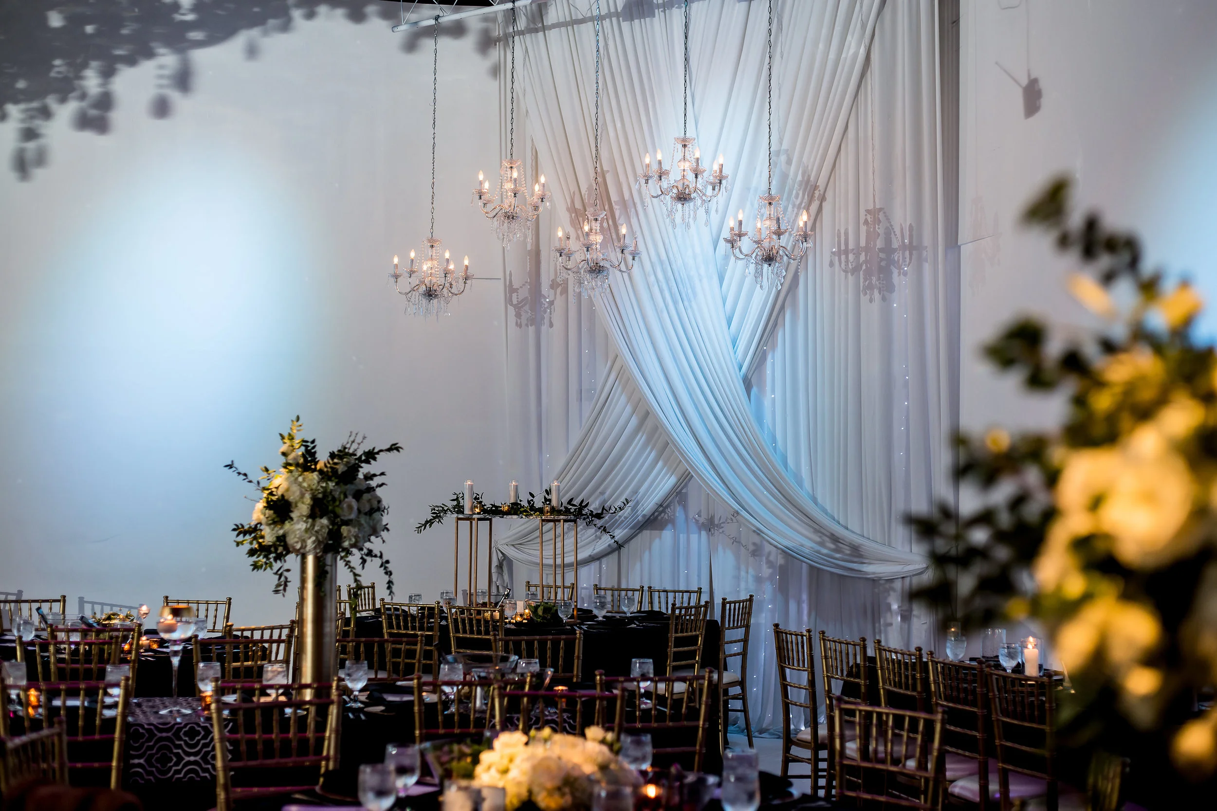 A shot of Amanda’s reception decor—She built those gold rectangle towers, added a marble topper, and supplied the candles!