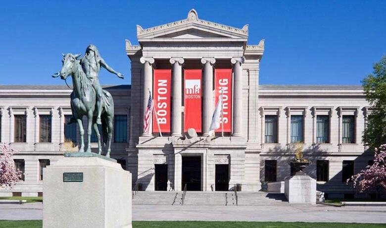 Boston Museum of Fine Arts stone building in Greek style with four columns and statue of man on horseback