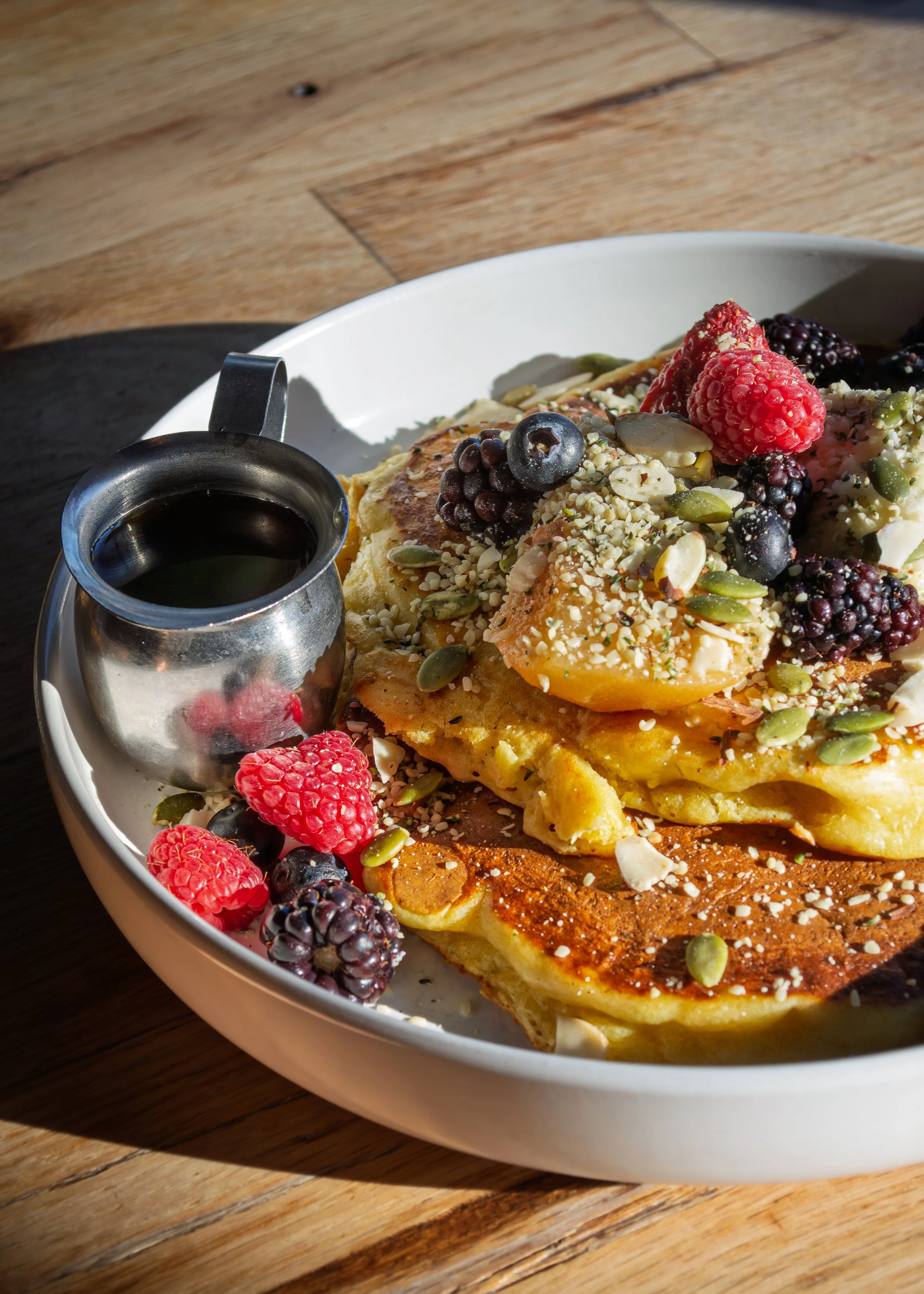 Lemon Ricotta Hotcakes with Pepitas, Fresh Raspberries, Blueberries, and Blackberries.