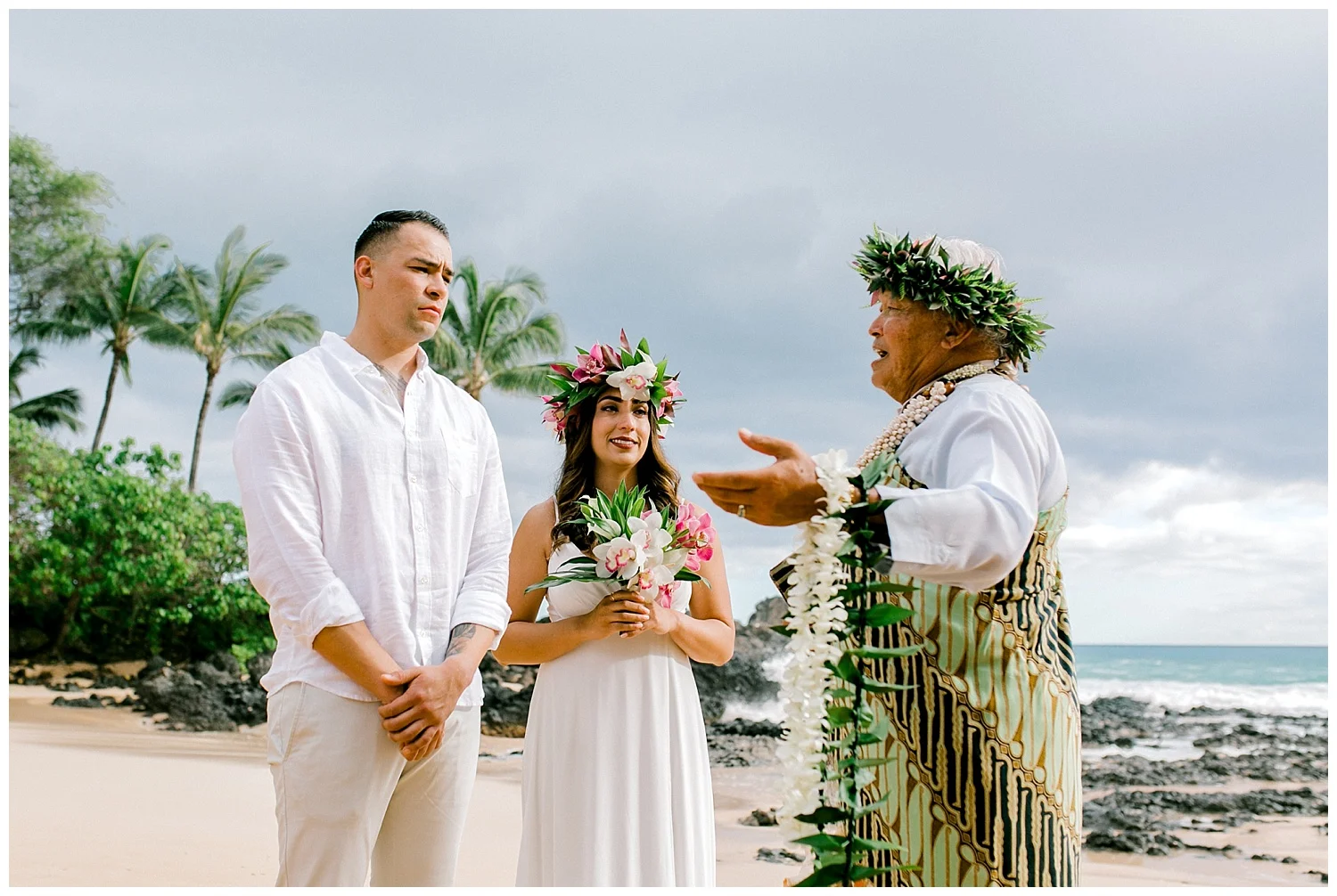 Bride and groom listening to officiant during Maui beach elopement ceremony