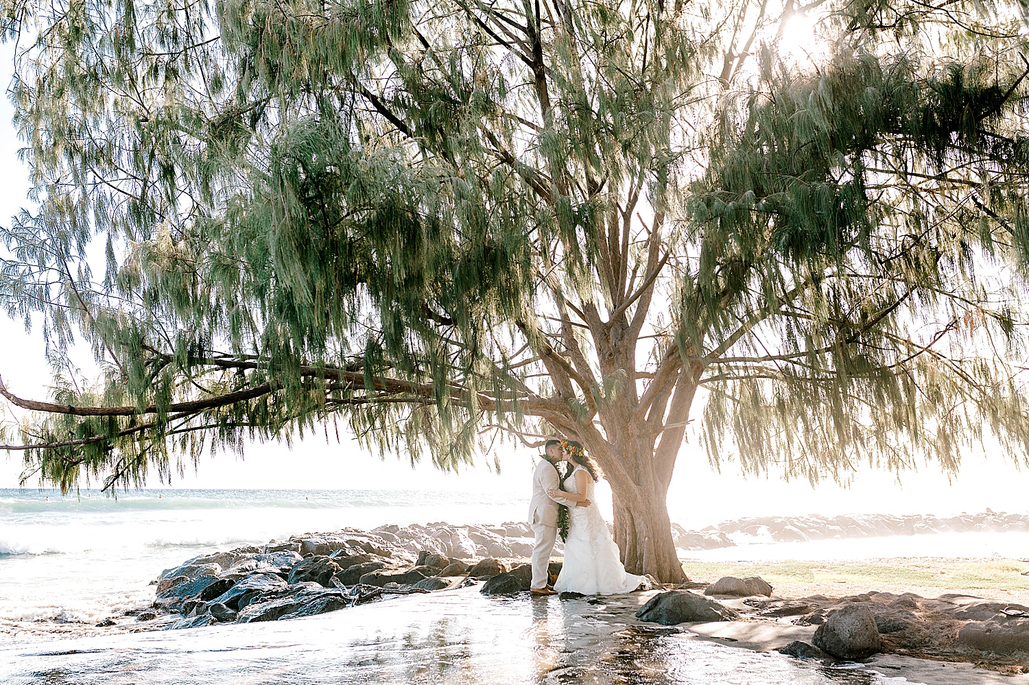 Bride and groom kissing at Launiupoko Beach