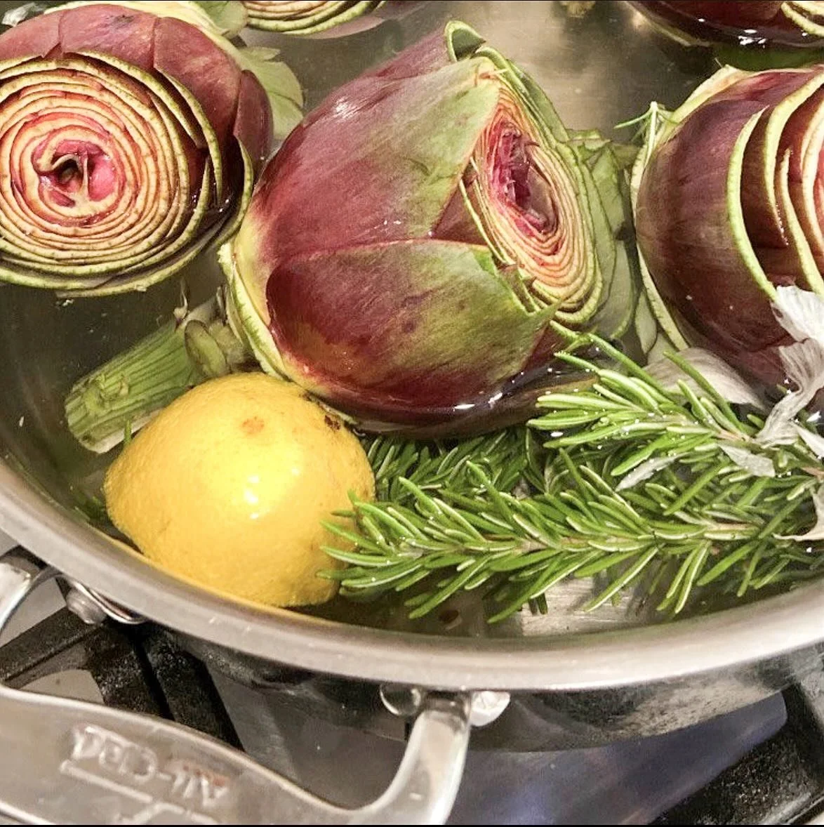 #meatlessmondays call for steamed artichoke hearts, no?

Ingredients:

water
2 lemons, halved
4 cloves of garlic
3 -4 stems of fresh rosemary
4 - 6 large artichokes

Directions:

Fill a large stock pot 3/4 of the way full with water. Add garlic and r